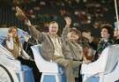 President George H.W. Bush and his wife Barbara (center rear) wave to the crowd during the grand entry parade at the Houston Livestock Show and Rodeo at Reliant Stadium in Houston, Texas March 1, 2007.