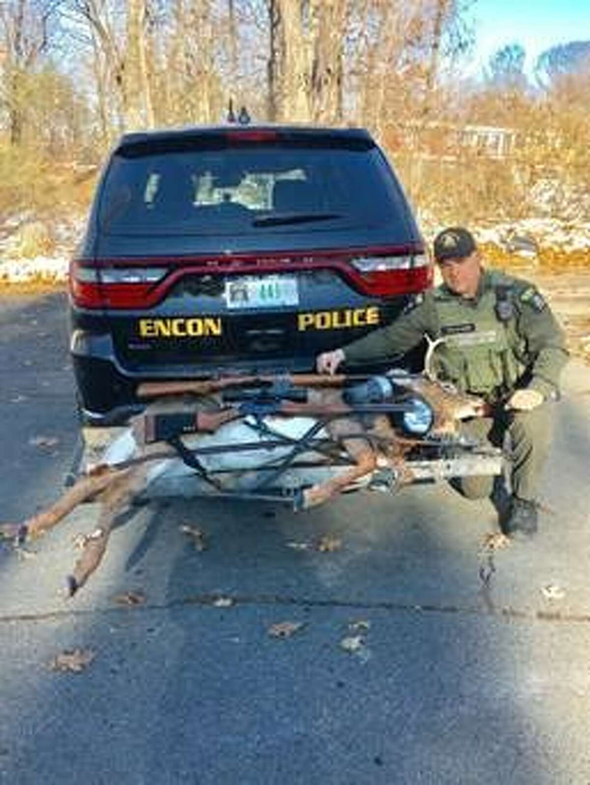 A state Department of Environmental Conservation officer poses with evidence seized during an investigation in to illegal hunting in Berne.