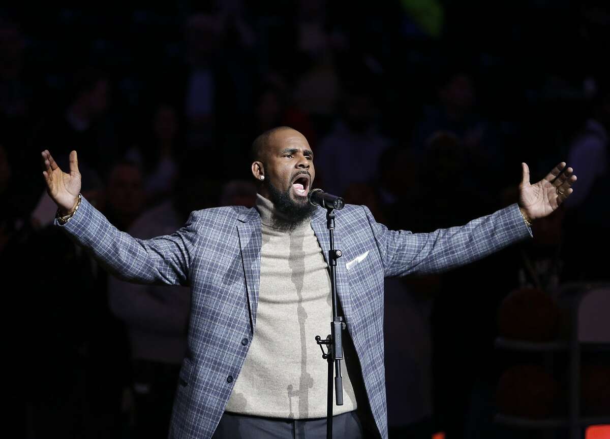FILE - In this Nov. 17, 2015, file photo, musical artist R. Kelly performs the national anthem before an NBA basketball game between the Brooklyn Nets and the Atlanta Hawks in New York. A screening of an upcoming documentary detailing abuse allegations against singer R. Kelly was evacuated after phone threats were made to the Manhattan location where it was being held. The New York Police Department says the threats to the NeueHouse Madison Square came in Tuesday night, Dec. 4, 2018, when it was hosting a screening of Lifetime’s “Surviving R. Kelly” series. (AP Photo/Frank Franklin II, File)