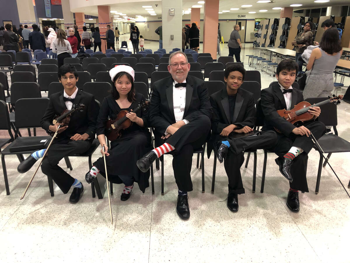 Shown with their crazy socks in honor of President Bush are (from left) Orchestra students Neel Jhangiani, Tiffany Nguyen, Director Brian Runnels, Anthony Duke and Brandon Musngi.