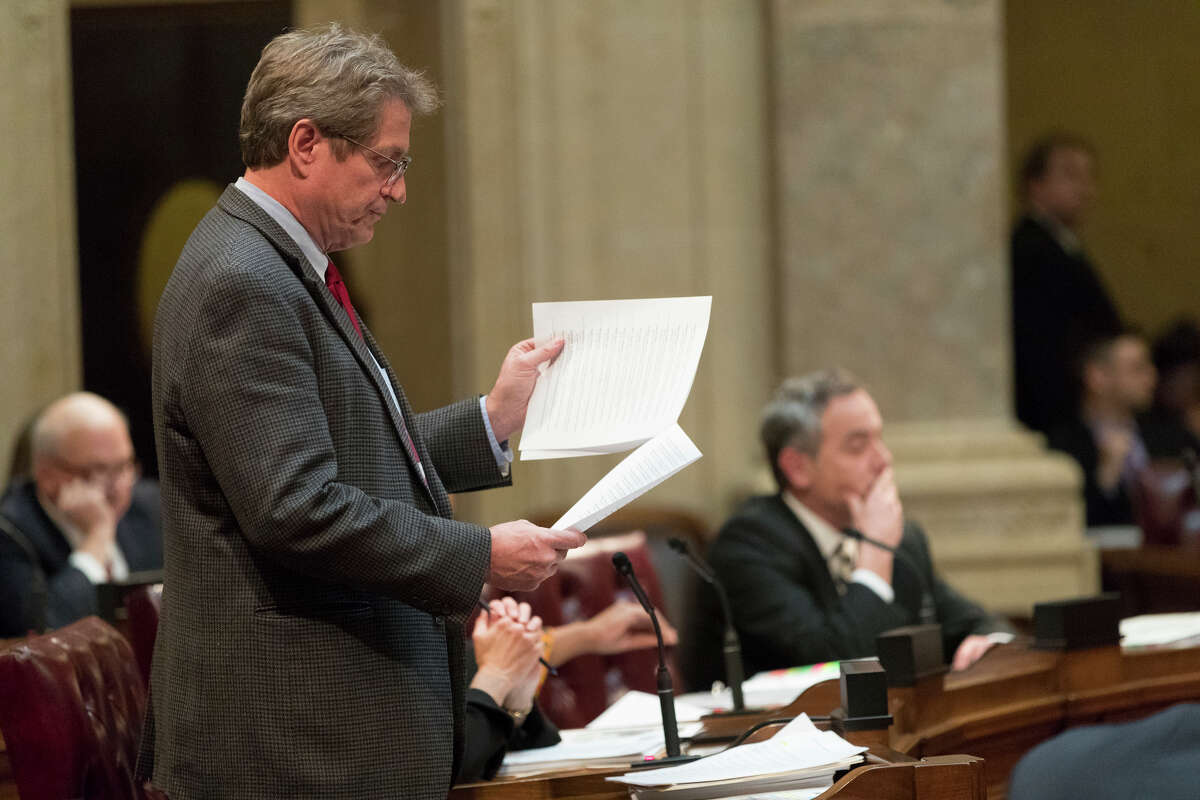 State Sen. Tim Carpenter, left, D-Milwaukee, questions a list of about fifty appointment referrals submitted to the State Senate at the Capitol in Madison, Wis., Tuesday, Dec. 4, 2018. Demonstrators booed outgoing Wisconsin Gov. Scott Walker on Tuesday during the Christmas tree-lighting ceremony, at times drowning out a high school choir with their own songs in protest of a Republican effort to gut the powers of his Democratic successor. (Mark Hoffman/Milwaukee Journal-Sentinel via AP)