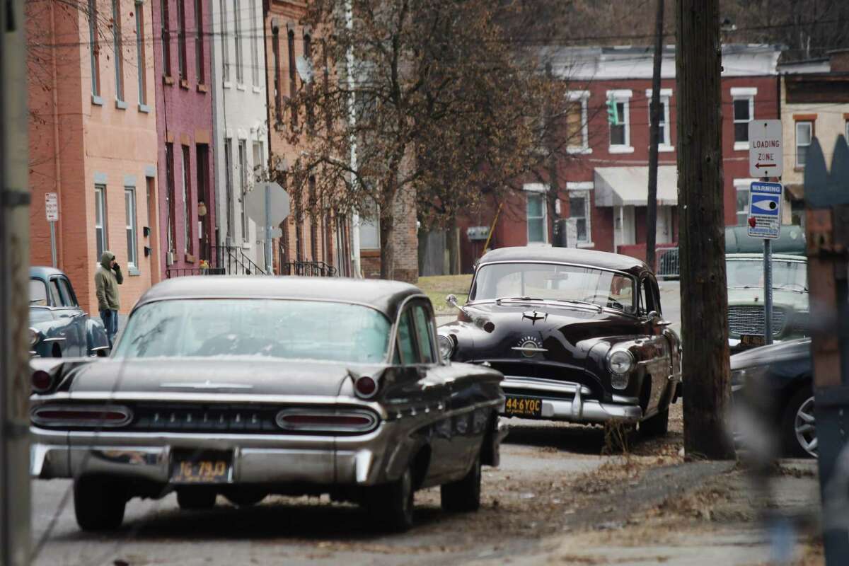 Click through to see a slideshow of movies filmed in the Capital Region.  Vintage cars are parked along Jefferson Street in Troy for the filming of a street scene for a movie being shot on Thursday, Dec. 6, 2018. (Paul Buckowski/Times Union)