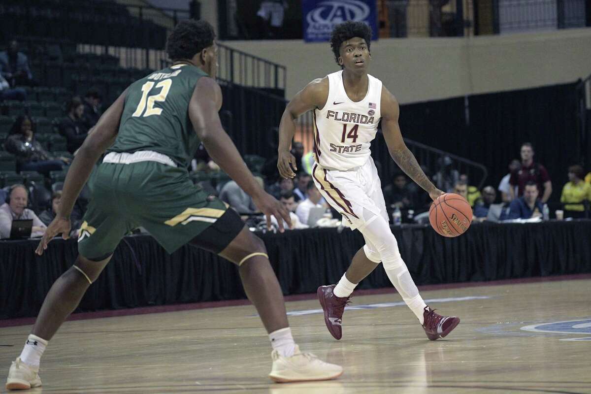 Florida State guard Terance Mann (14) sets up a play in front of UAB forward Will Butler during the first half of a game on Nov. 22 in Lake Buena Vista, Fla.