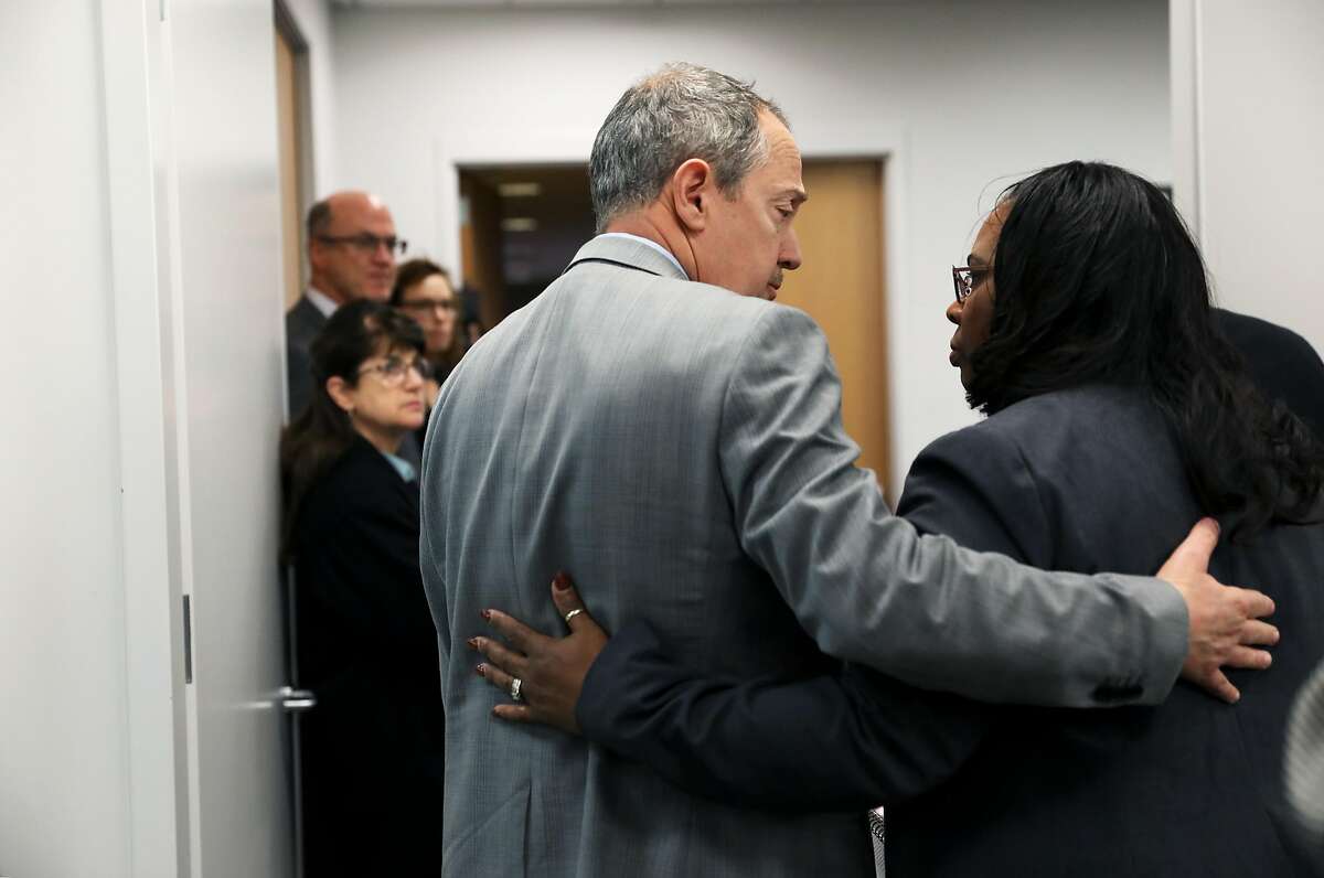 BART director Bevan Dufty of District 9 talks to Wanda Johnson, Oscar Grant's mother, as she exits a meeting at the San Francisco Bay Area Rapid Transit District Board of Directors in Oakland, Calif., on Thursday, December 6, 2018. A couple of BART board members, including Debora Allen of Danville, are upset about the planned Oscar Grant mural at the Fruitvale BART station and they aired their differences at the meeting Thursday morning.