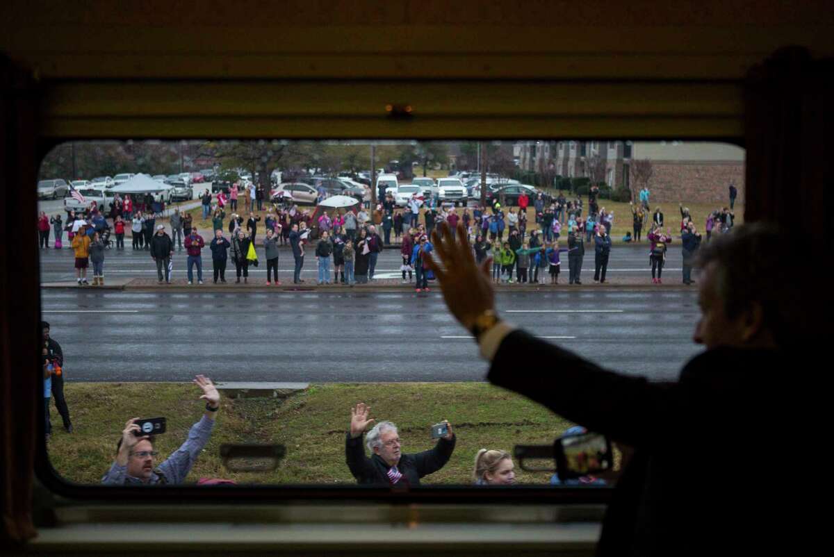 People watch along the route as the train carrying former President George H.W. Bush travels from Houston to College Station for President Bush's burial, Thursday, Dec. 6, 2018.