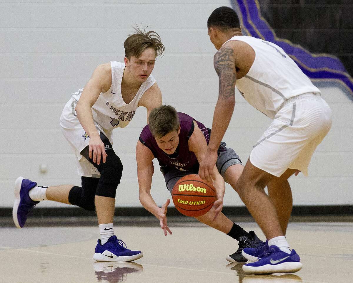 Magnolia guard Connor Lindvall (11) steals the ball between Lufkin guards Carter Jones (4) and Bugg Thompson (1) cduring the first quarter of a game at the Schurr Insurance Holiday Classic at Montgomery High School, Thursday, Dec. 6, 2018, in Montgomery.
