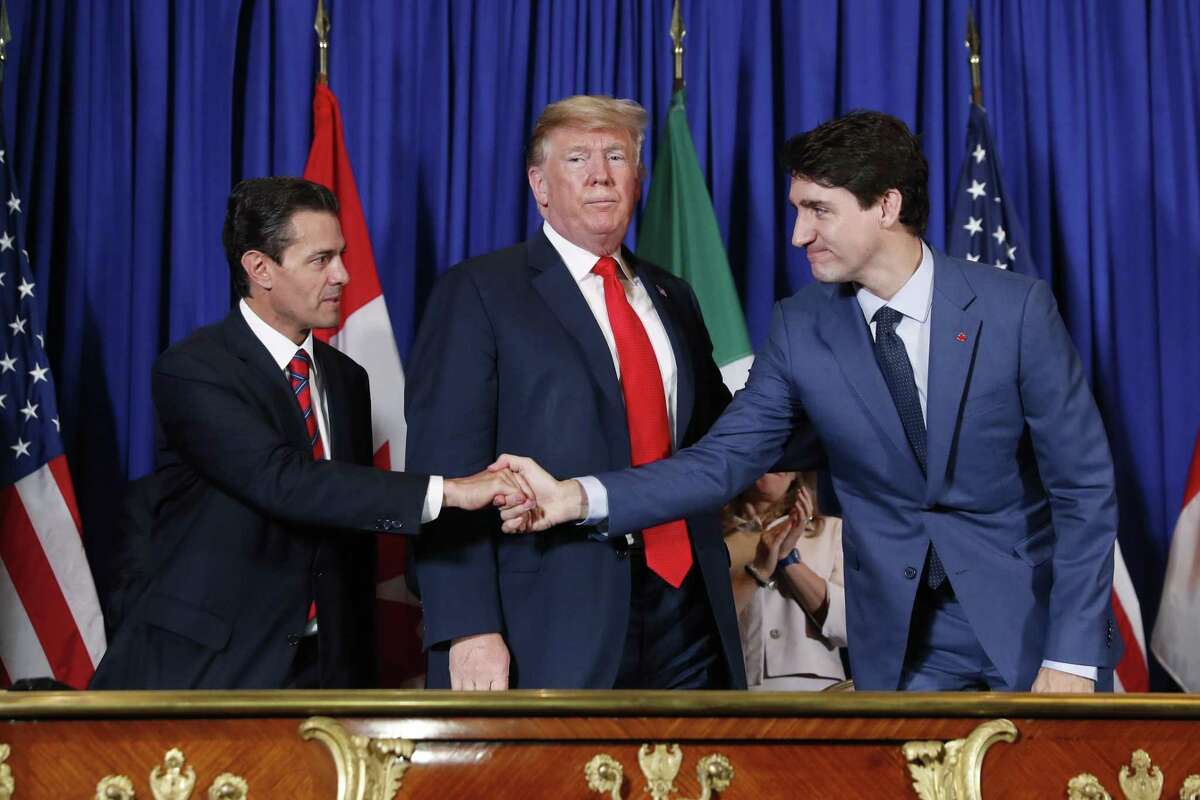 CORRECTS SPELLING OF NIETO - President Donald Trump, Canada's Prime Minister Justin Trudeau, right, and Mexico's President Enrique Pena Nieto, left, participate in the USMCA signing ceremony, Friday, Nov. 30, 2018 in Buenos Aires, Argentina. (AP Photo/Pablo Martinez Monsivais)