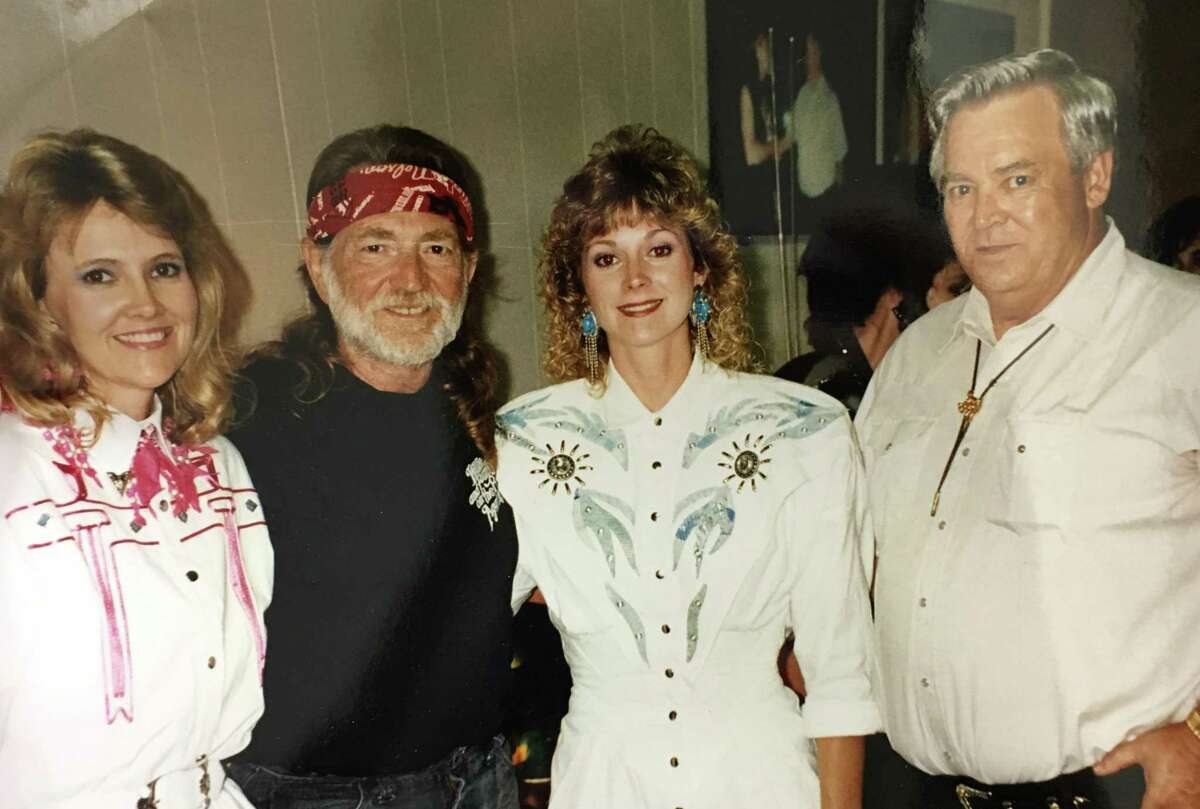 John Perry Holmes, right, with his daughters, Cindy and Jenny, and Willie Nelson when Holmes owned Willie's Night Life night club.