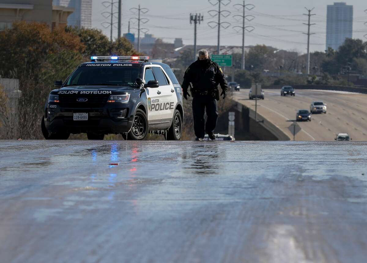 Houston Police divert traffic off of IH-69 near the Weslayan Street and Newcastle Drive exits because of ice on the roadway, Wednesday, Jan. 17, 2018, in Houston.