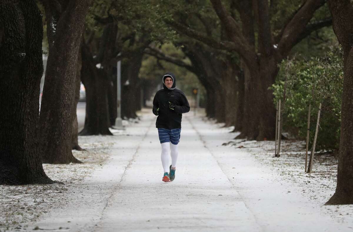 Anthony Heins runs along Main Street near Rice University as a mixture of snow and sleet falls, Tuesday, Jan. 16, 2017 in Houston. "It's not that bad really," Heins said.