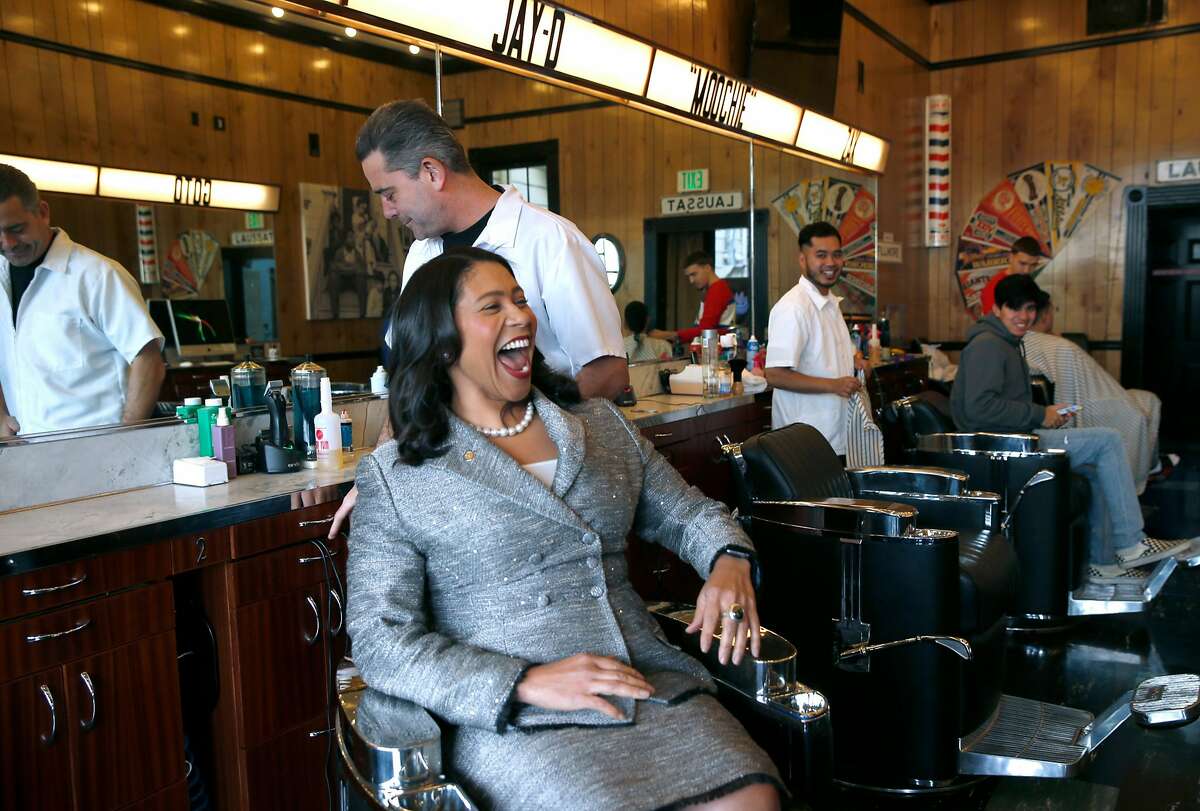 Mayor London Breed stops by to visit with Mike Stevens in his barber shop on lower Haight Street in San Francisco, Calif. on Friday, Dec. 7, 2018. Next week, Mayor Breed will announce an initiative to address retail vacancies throughout the city.