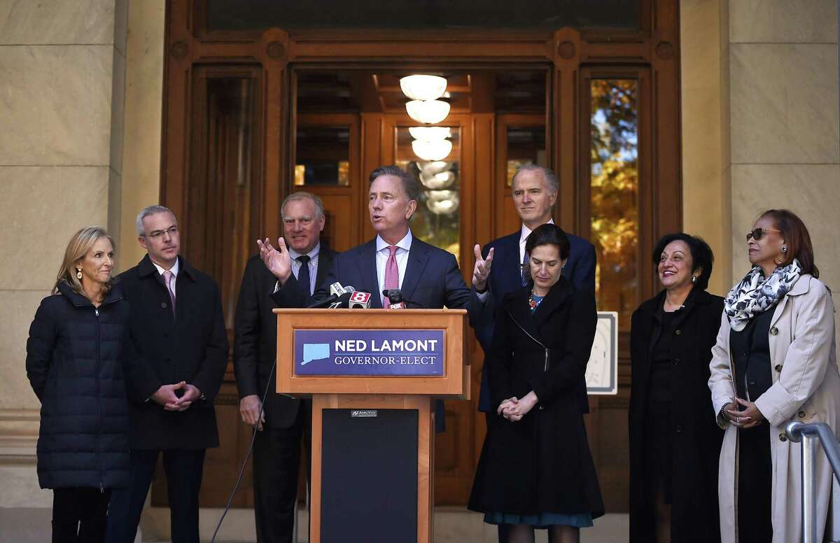 Governor-elect Ned Lamont with his transition team last month at the State Capitol. From the left is wife Annie Lamont and transition team members Ryan Drajewicz, the incoming chief of staff; Attorney General George Jepsen; Garrett Moran; Lieutenant Governor-elect Susan Bysiewicz; Dr. Elsa Nunez; and State Rep. Toni Walker. (AP Photo/Jessica Hill)
