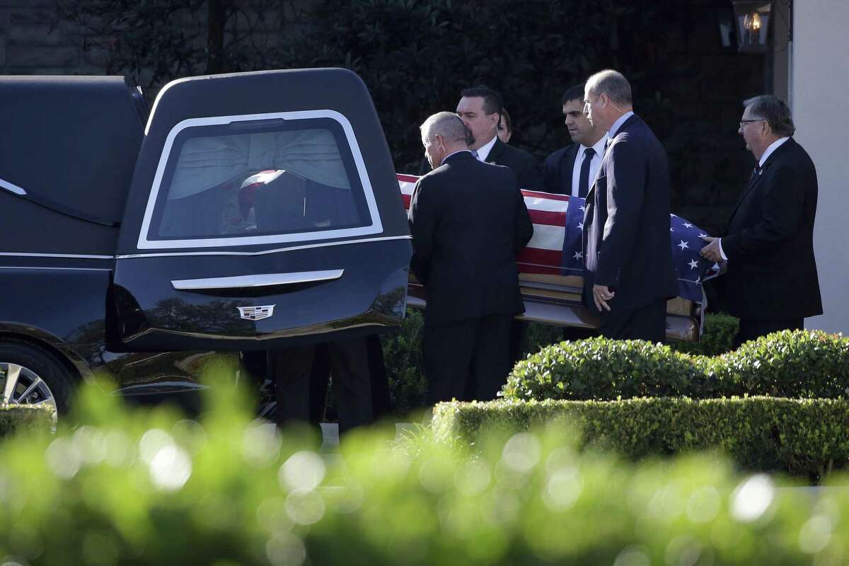 Members of the U.S. Secret Service carry the casket of former President George H.W. Bush after a family service Monday in Houston. A reader draws contrasts between Presidents Bush and Donald Trump.