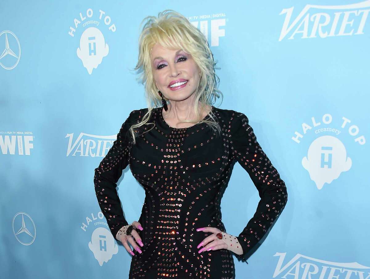 FILE - In this Sept. 15, 2017 file photo, Dolly Parton arrives at the 69th Primetime Emmy Awards Variety and Women in Film pre-Emmy celebration in Los Angeles. Parton on Thursday, Dec. 6, 2018, was nominated for a Golden Globe for "The Girl in the Movies," which she co-wrote with Linda Perry. (Photo by Jordan Strauss/Invision/AP, File)