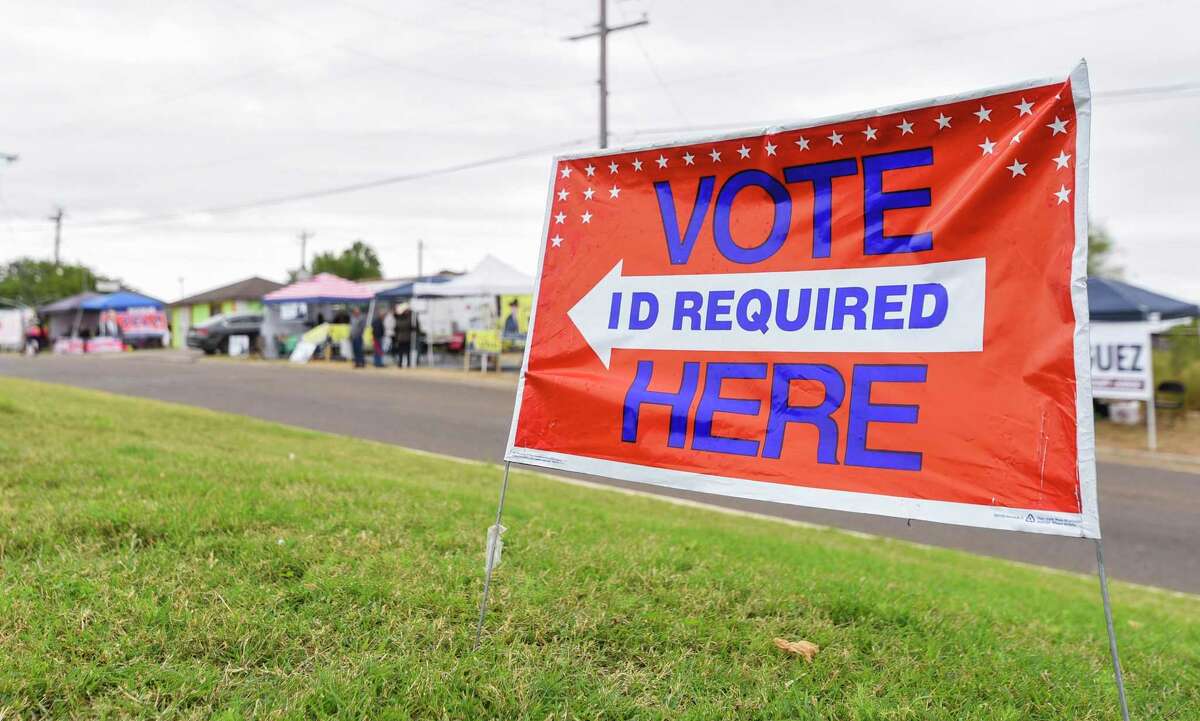 In this file photo, a sign directing voters to a polling place is seen in Laredo.