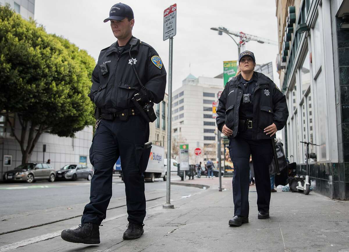 SFPD Officer Maher (left) and Officer Richmond patrol Grove Street near the Civic Center Plaza area in San Francisco, Calif. on Tuesday, Dec. 4, 2018.