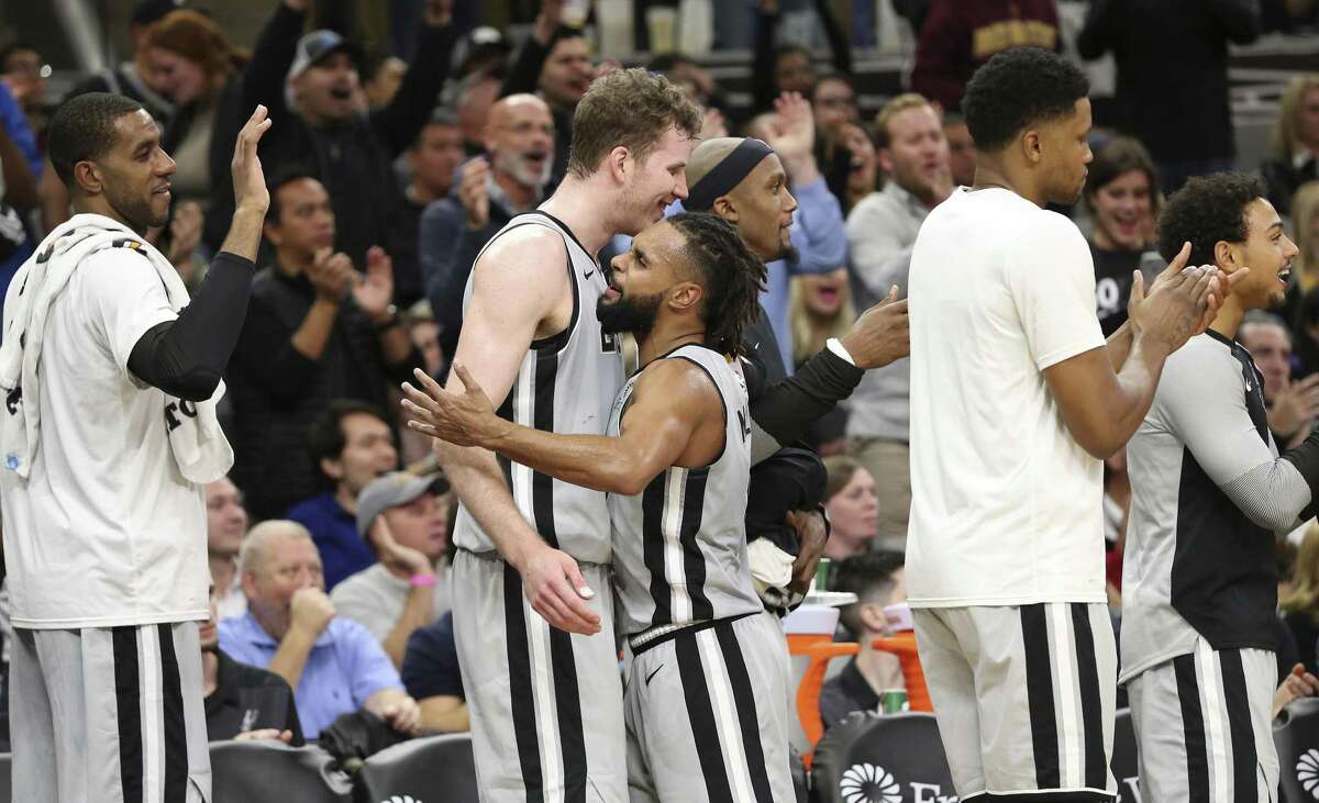 Spurs' Patty Mills (08) congratulates Jakob Poeltl (25) in the closing moments of the game against the Los Angeles Lakers at the AT&T Center on Friday, Dec. 7, 2018. Spurs come from behind to defeat the Lakers four-game win streak, 133-120. (Kin Man Hui/San Antonio Express-News)