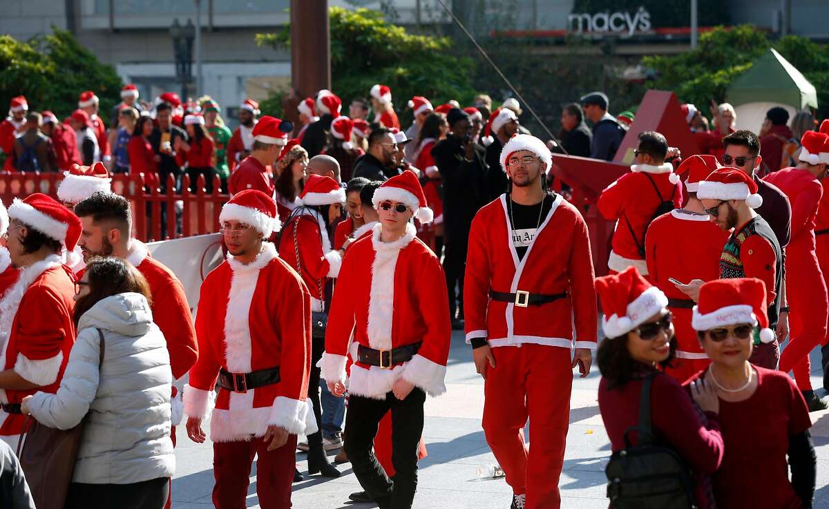 Costumed revelers wander through Union Square for the annual SantaCon gathering in San Francisco, Calif. on Saturday, Dec. 8, 2018. The event was held despite the denial of a permit issued by the city.