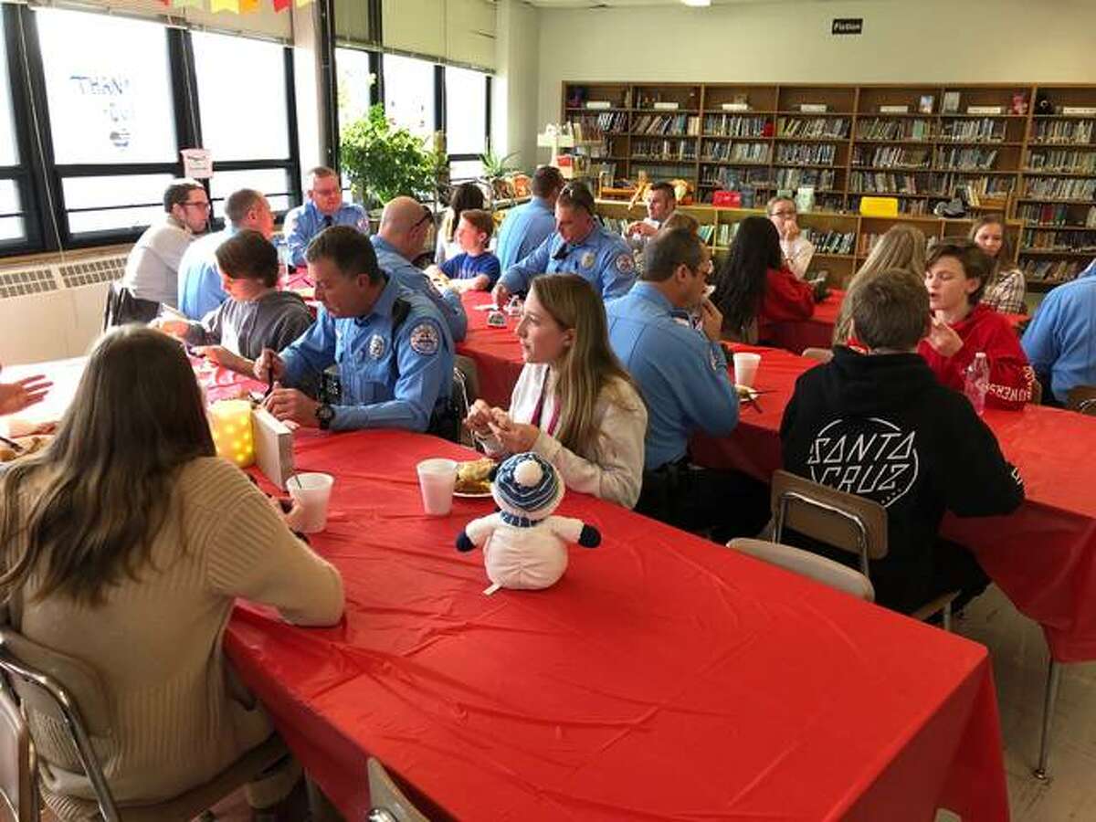 Edwardsville police officers enjoy lunch and the company of Lincoln Middle School eighth-graders during the Lincoln Middle School First Responders’ Luncheon this week.