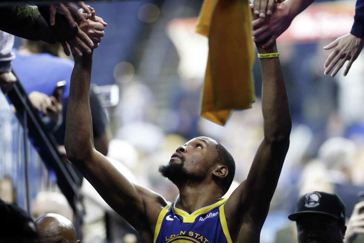 Golden State Warriors' Kevin Durant greets fans after scoring 49 points during 116-110 win over Orlando Magic during NBA game at Oracle Arena in Oaklan on Monday, November 26, 2018.