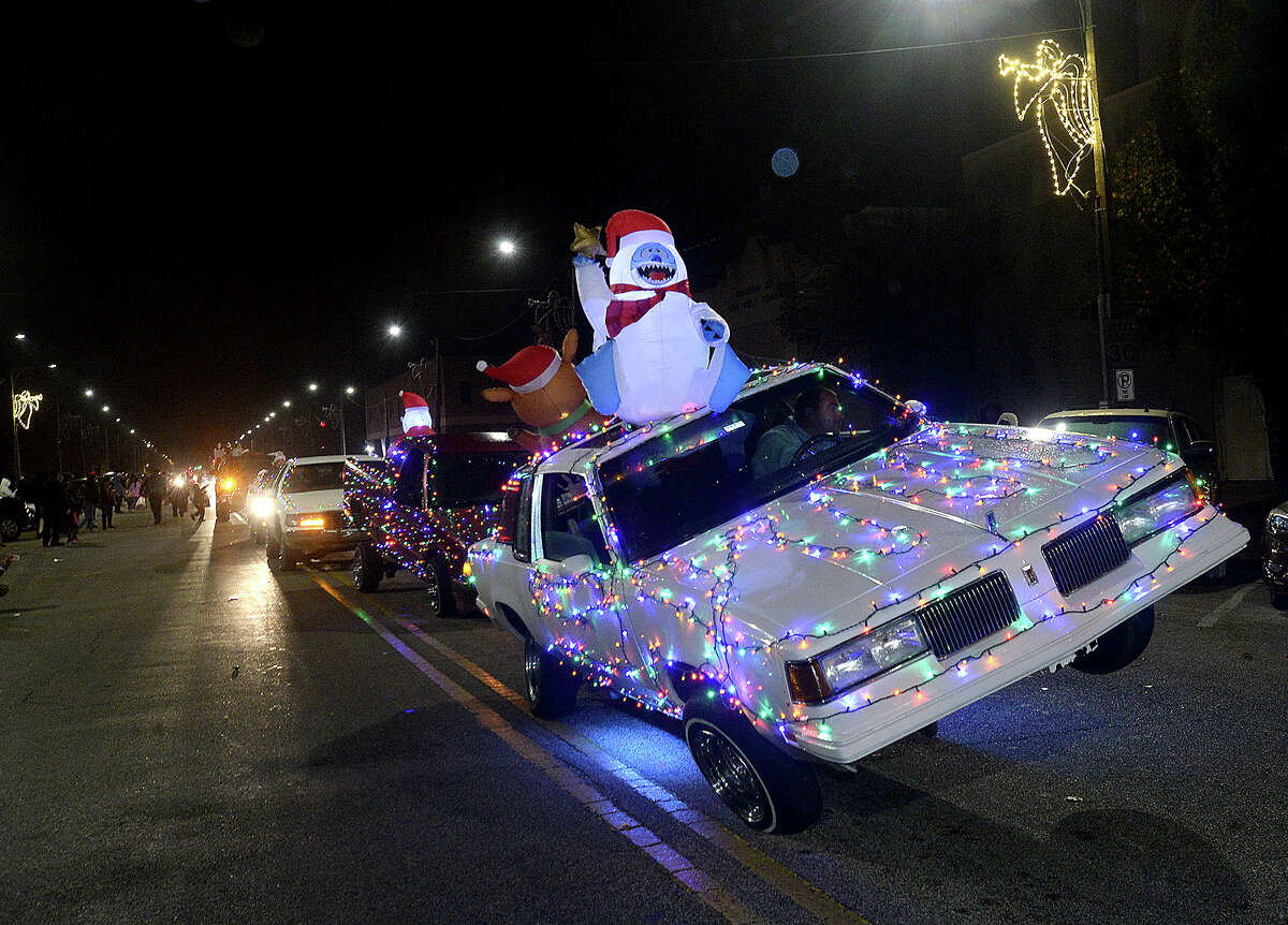 Festive parade participants make their way down Procter Street during the City of Port Arthur's annual lighted Holiday Parade Saturday night. Photo taken Saturday, December 8, 2018 Kim Brent/The Enterprise
