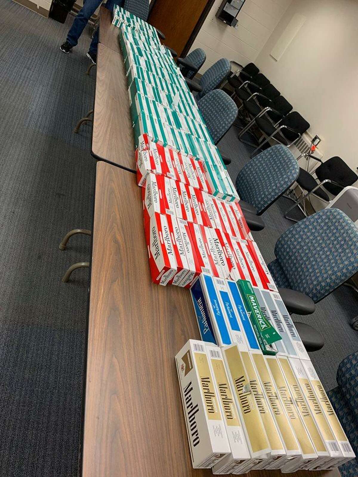 Police seized gambling records, nearly 150 cartons of untaxed cigarettes and more than $780 during a traffic stop on Friday.