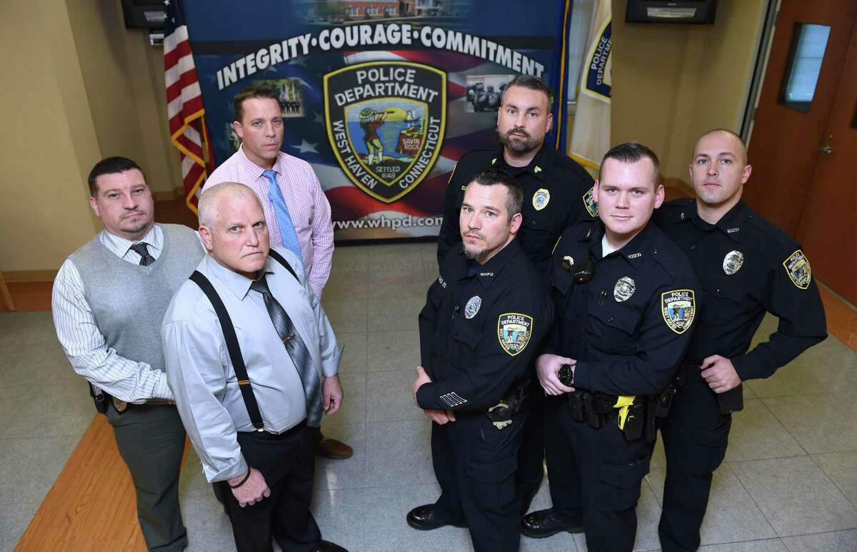 Clockwise from far left, Capt. Carl V. Flemmig, Detective Sean Faughnan, Training Sgt. Scott Kleinknecht, Officer Craig Thompson, Officer Paul Butler, Officer Scott Allard and Dep. Chief Joseph Perno at the West Haven Police Department recently.