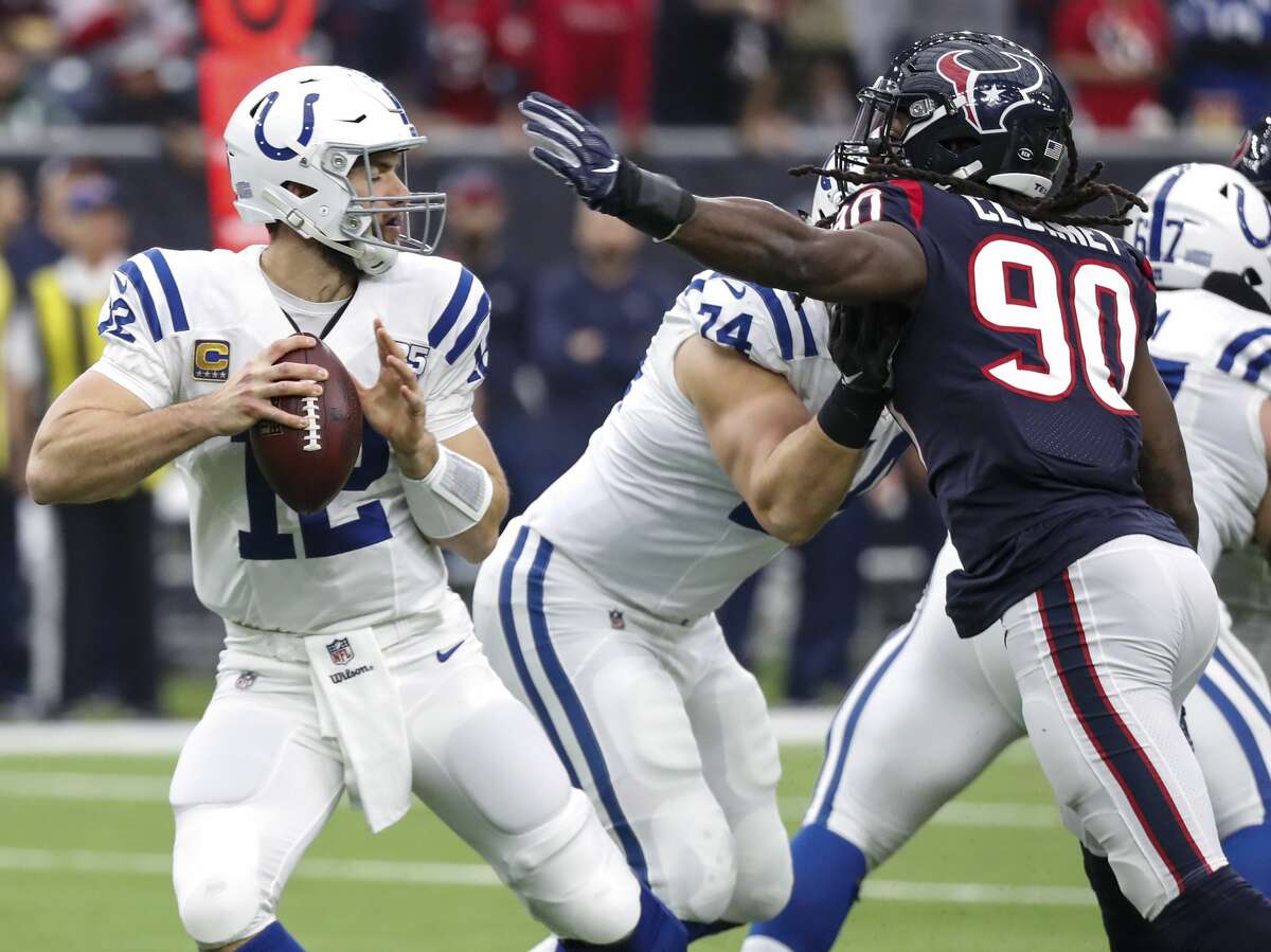 Indianapolis Colts quarterback Andrew Luck (12) dodges the outstretched arm of Houston Texans outside linebacker Jadeveon Clowney (90) during the first quarter of an NFL football game at NRG Stadium on Sunday, Dec. 9, 2018, in Houston.