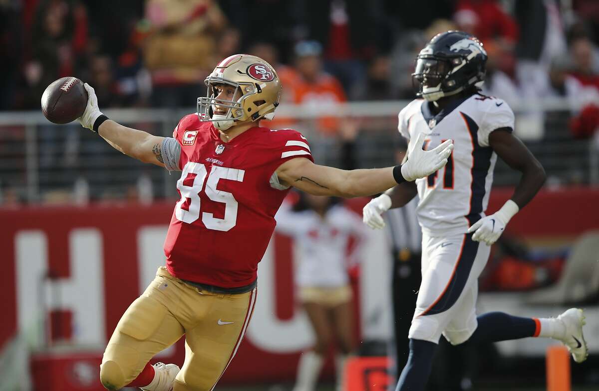 San Francisco 49ers tight end George Kittle (85) stiff-arms Los Angeles  Rams cornerback Marcus …