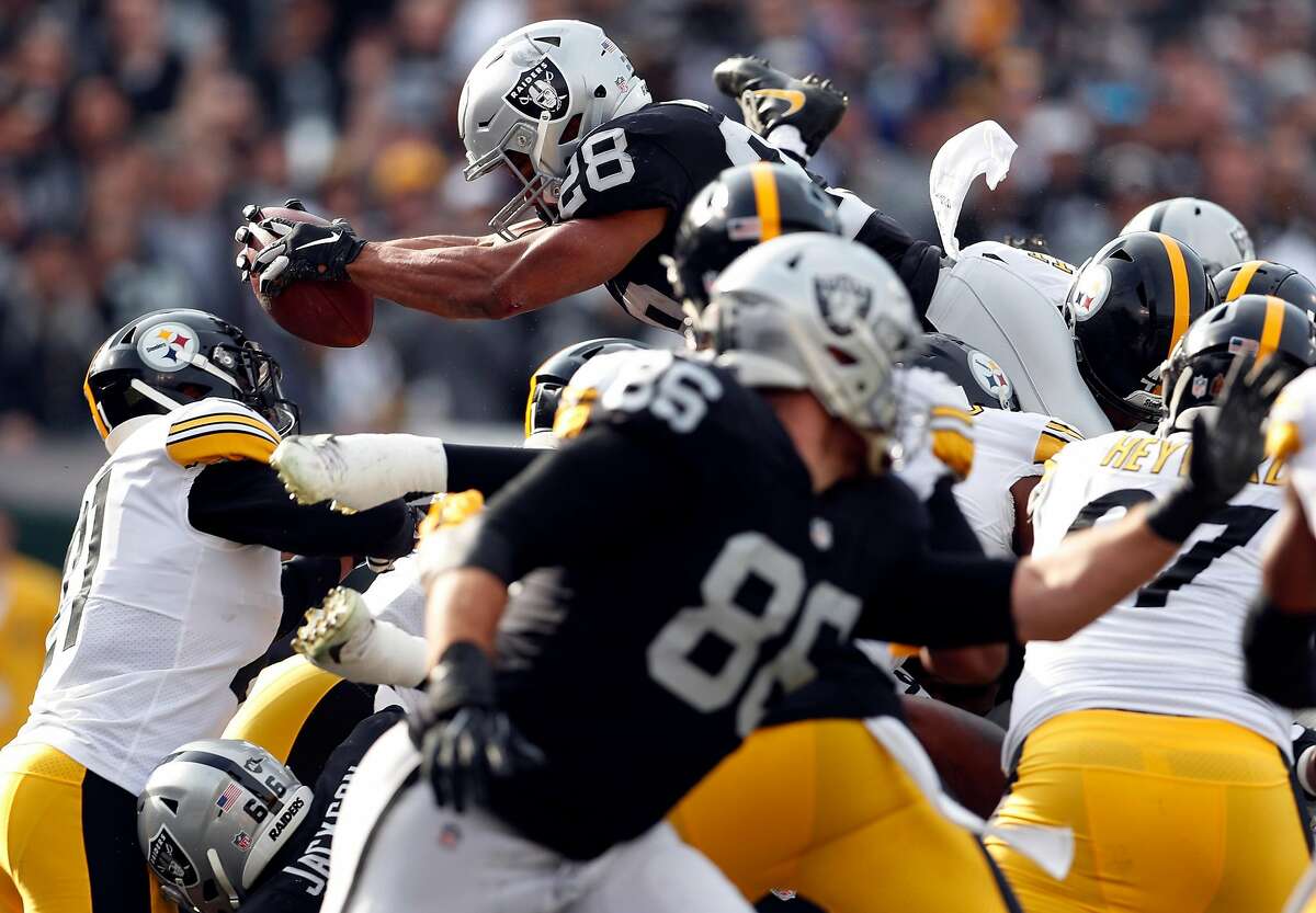 Oakland Raiders' Doug Martin dives for a touchdown in 1st quarter against Pittsburgh Steelers during NFL game at Oakland Coliseum in Oakland, Calif. on Sunday, December 9, 2018.