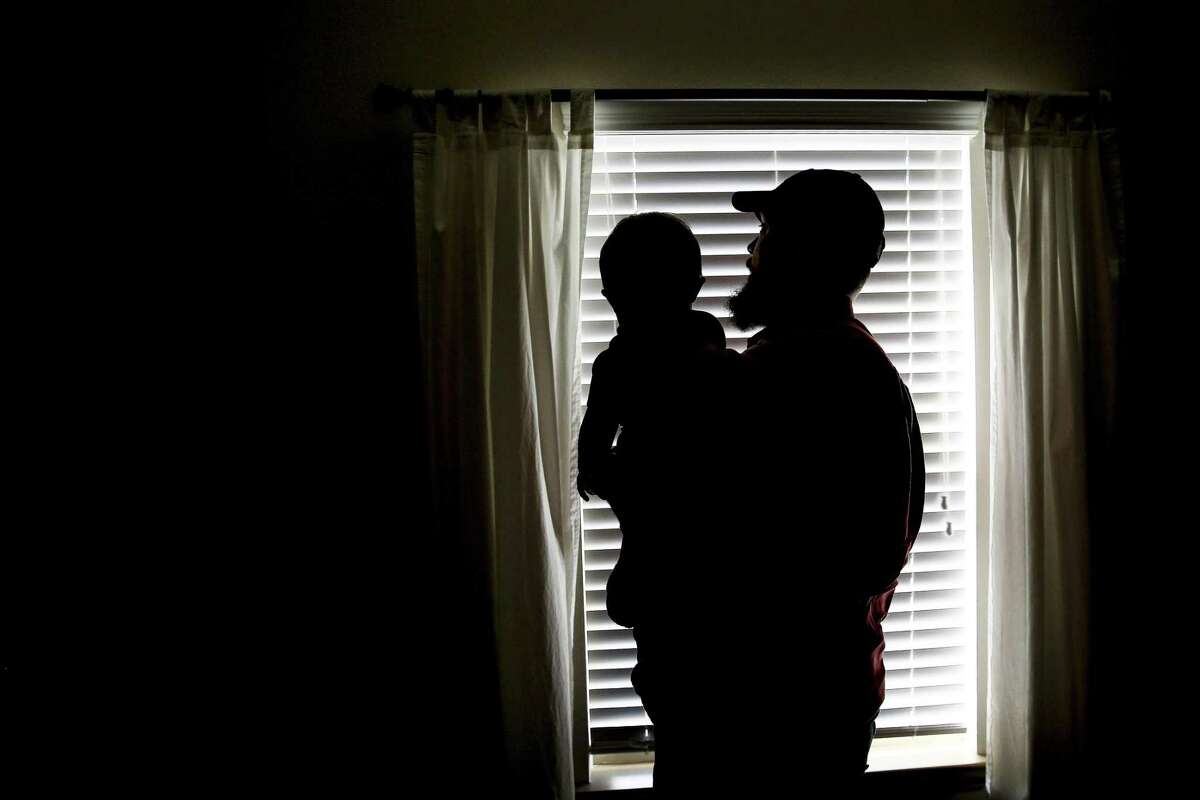 Dillon Bright holds his nine-month-old son, Mason Bright, before nap time Saturday, Nov. 3, 2018, in Tomball. Child Protective Services is facing sanctions after improperly removing the Bright's children from their home after Mason fell and fractured his skull when he was five months old.
