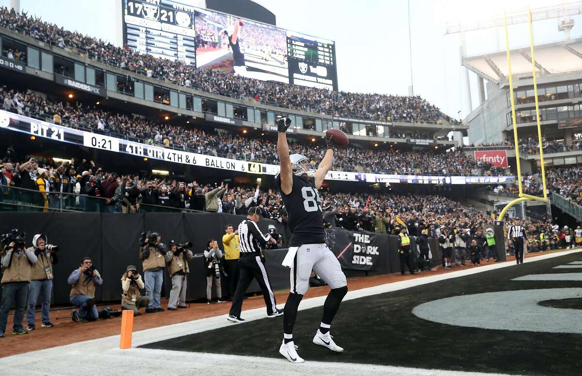 Oakland Raiders' Derek Carrier celebrates catching the go ahead touchdown in the final minute of the team's 24-21 win over Pittsburgh at the Coliseum on December 9, 2018.