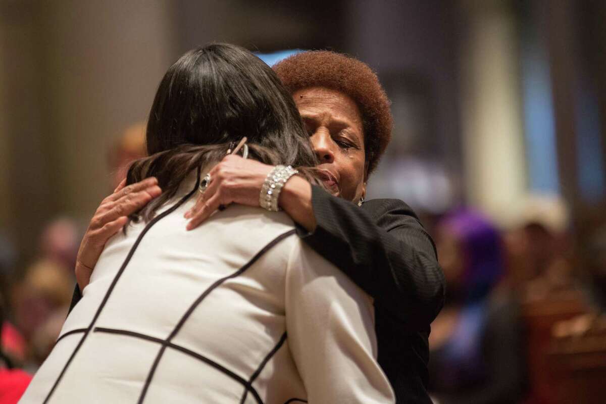 San Francisco Mayor London Breed (left) embraces Mattie Scott, a gun violence survivor and president of the S.F. chapter of the Brady Campaign, during the vigil to honor victims of gun violence at St. Ignatius Church.