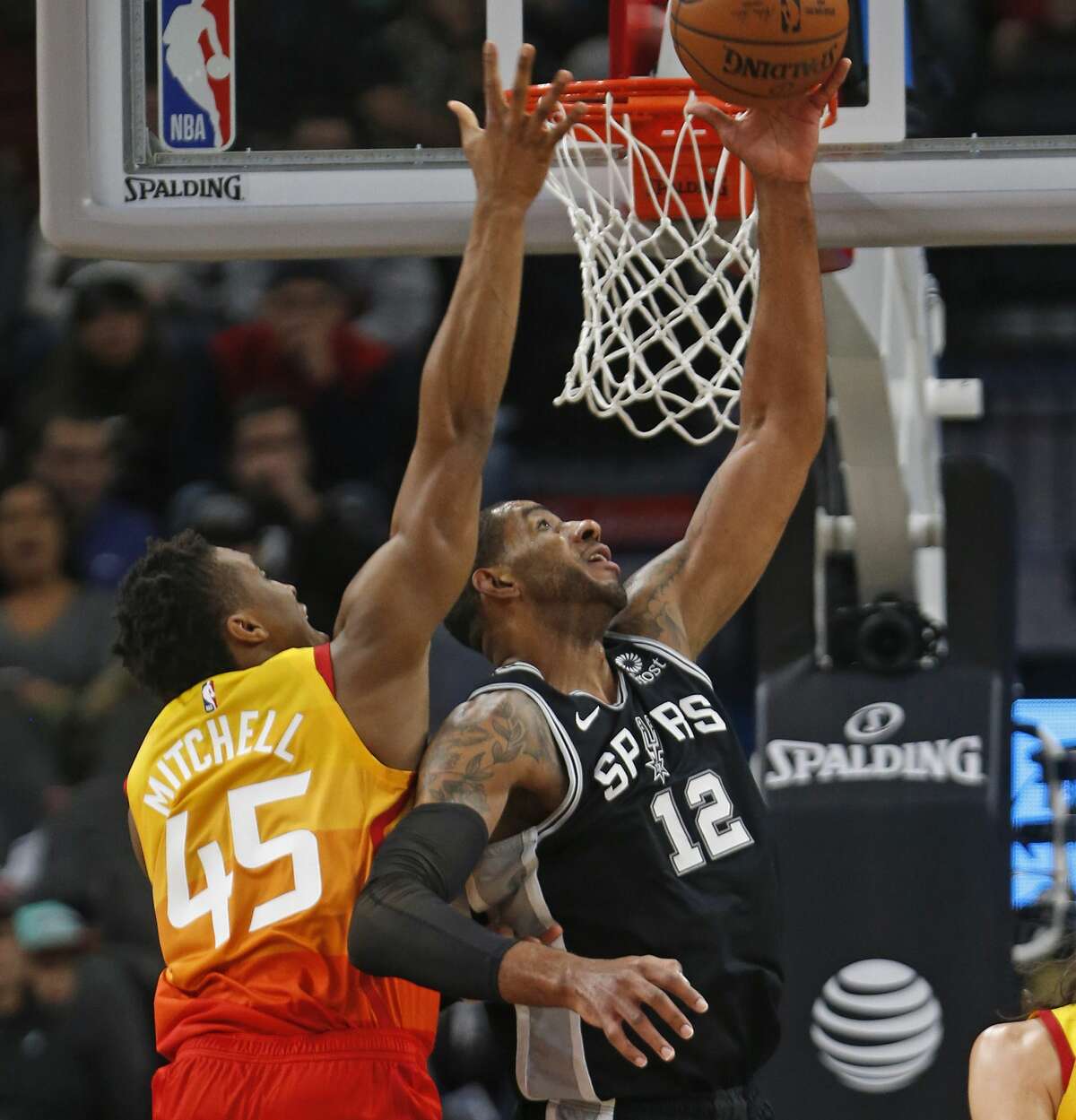 LaMarcus Aldridge #12 of the San Antonio Spurs scores over Donovan Mitchell #45 of the Utah Jazz. Utah Jazz v San Antonio Spurs on Sunday, December 9, 2018 at the AT&T Center.