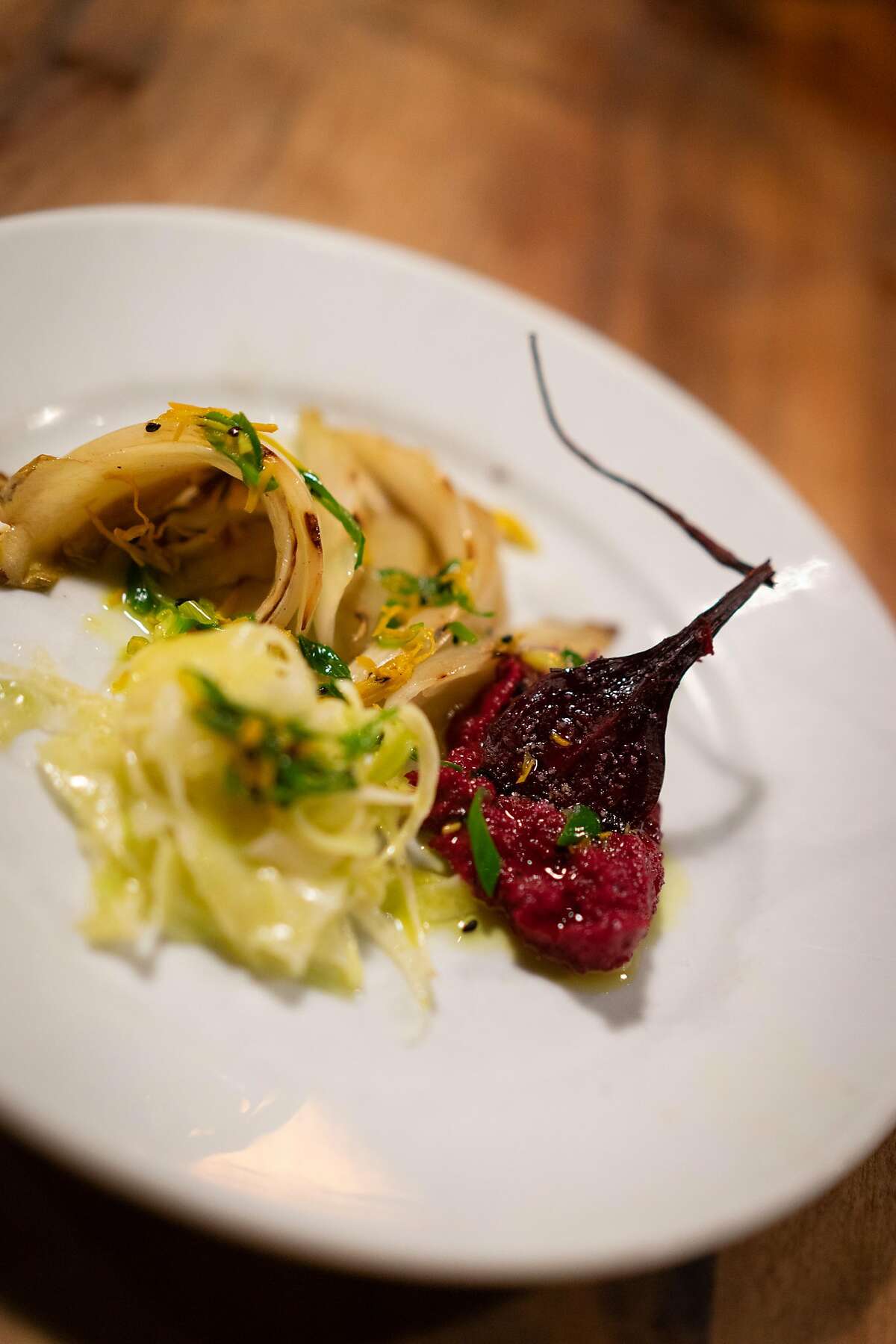 Beet, grilled Belgian endive and fennel salad with fresh turmeric is served as a first course at Camino restaurant in Oakland, Calif., on Friday, Dec. 7, 2018.