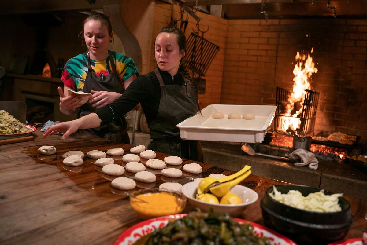 (Left) Ellyn Thompson and Lauren Giunta prepare balls of dough at Camino restaurant in Oakland, Calif., on Friday, Dec. 7, 2018.