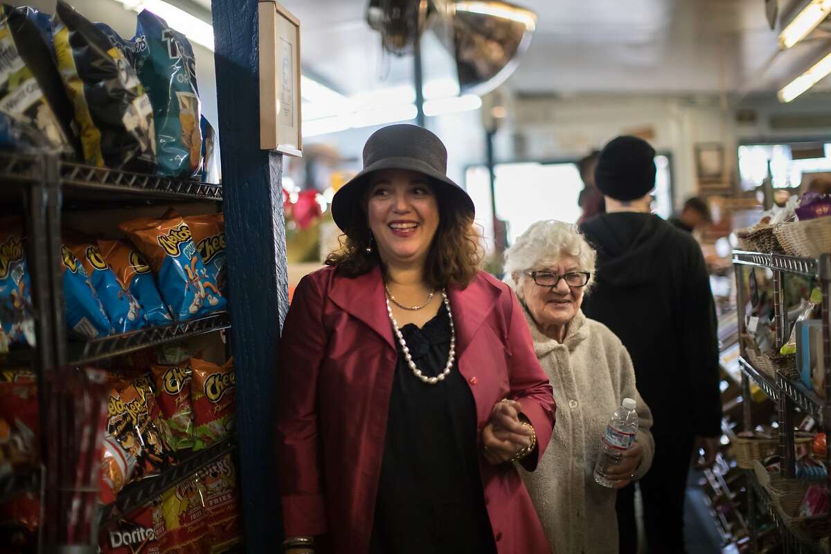 Lorene Zarou-Zouzounis introduces her mom, Salimeh Zarou, 86, to employees at Ted's Market for on Friday, Dec. 7, 2018, in San Francisco, Calif.