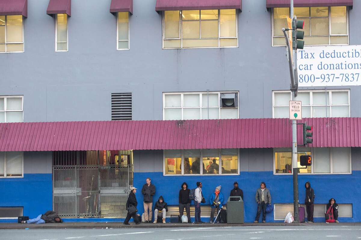 Patrons lining up outside of the St. Vincent de Paul shelter before it opens at 5 p.m on Sunday, December 9, 2018 in San Francisco, Calif.