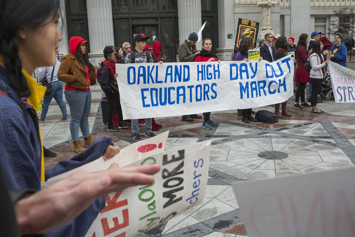 FILE — Joined by students and supporters, teachers from Oakland High and other schools, gather to protest their wages outside Oakland City Hall on Monday, December 10, 2018 in Oakland, Calif.