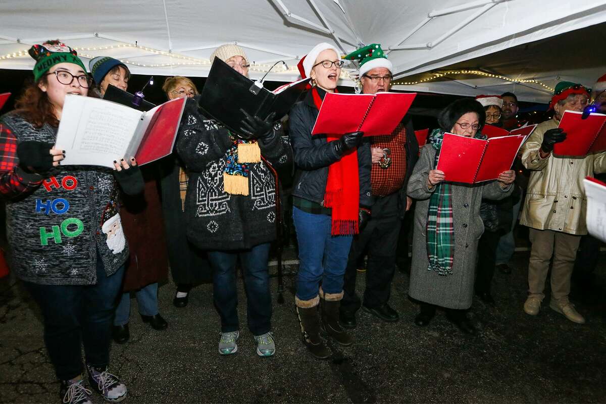 The San Antonio Symphony Master Singers sing carols during the 60th Annual Windcrest Light-Up at City Hall on Saturday.