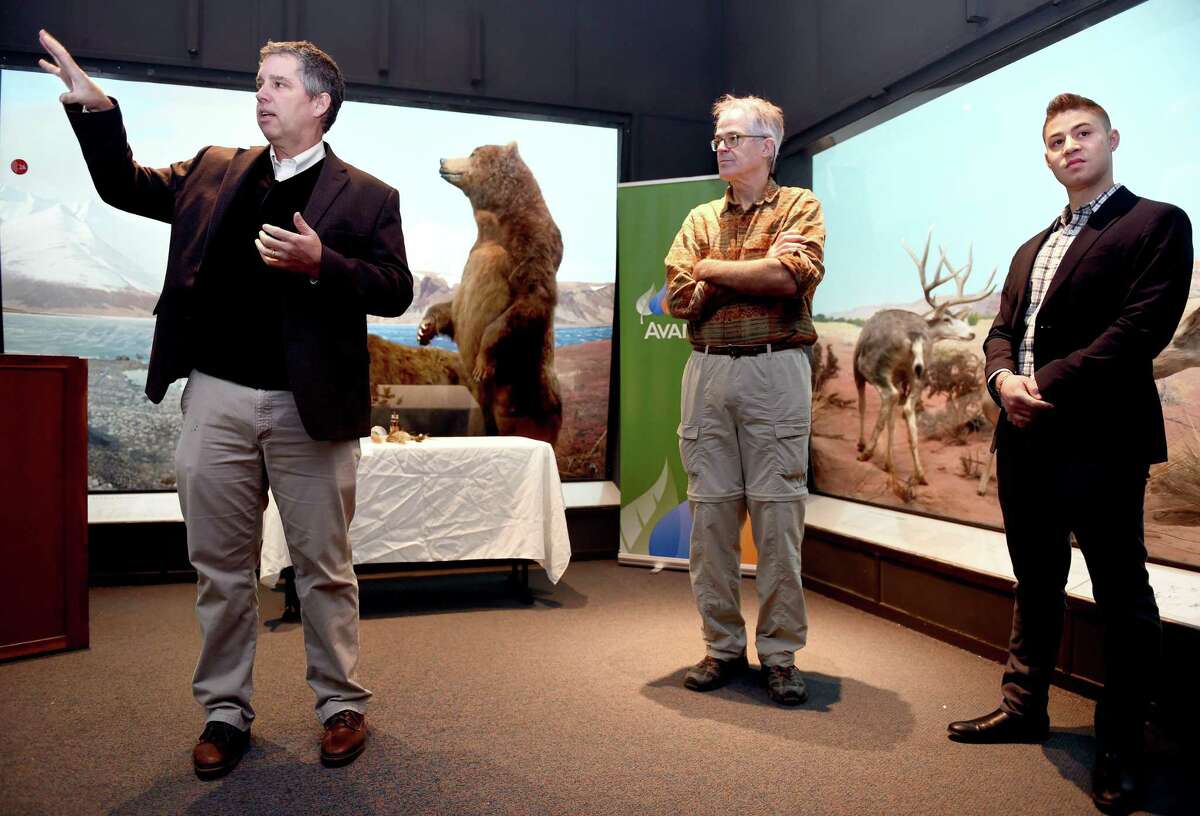David Skelly, left, director of the Yale Peabody Museum of Natural History, talks about the North American dioramas restoration project at the museum in New Haven Monday. Listening is museum preparator and sculptor Michael Anderson, center, and Collin Moret, assistant to museum preparator.
