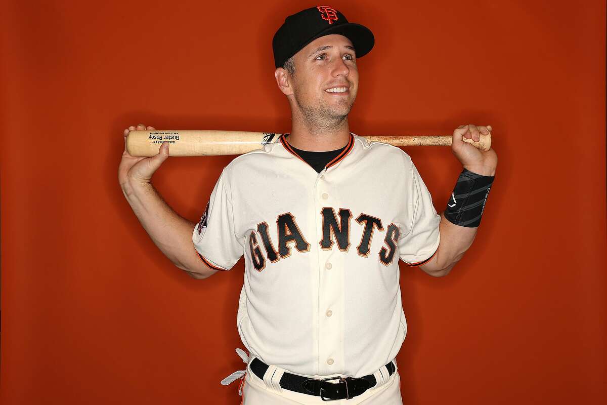 Buster Posey back with Giants after opting out, slinging diapers