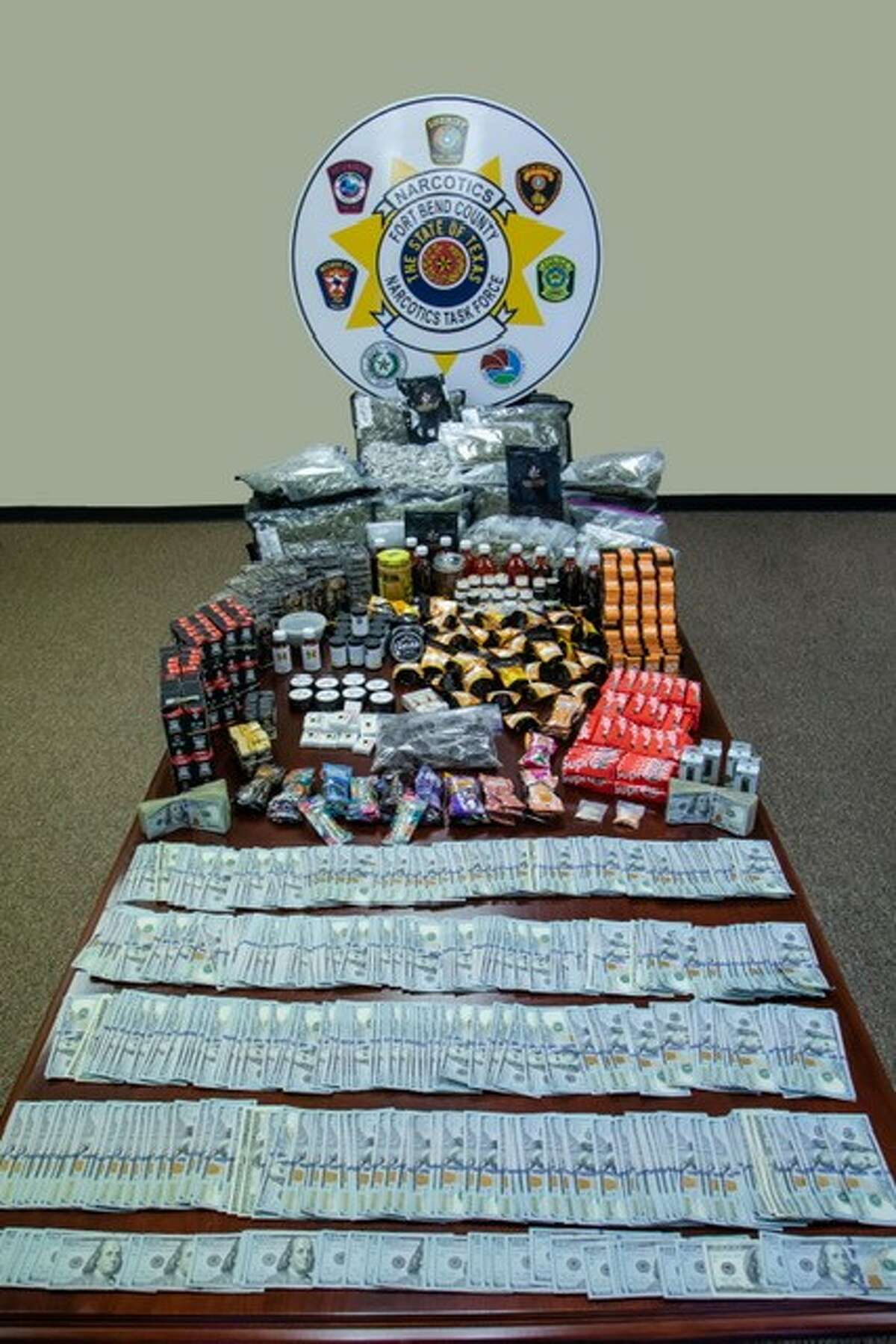 The Fort Bend County Sheriff's Office shows off a haul of drugs, paraphernalia and money seized during a recent drug bust.