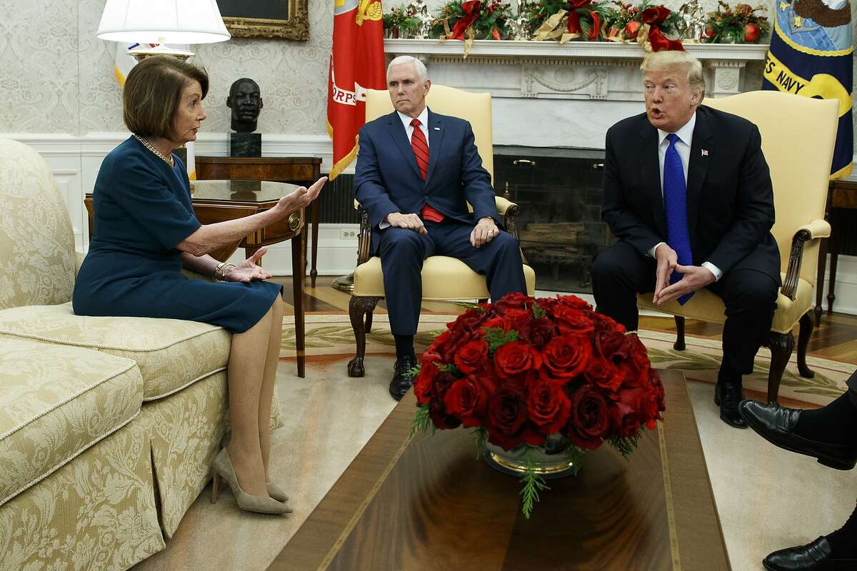 Vice President Mike Pence, center, looks on as House Minority Leader Rep. Nancy Pelosi, D-Calif., and President Donald Trump argue during a meeting in the Oval Office of the White House, Tuesday, Dec. 11, 2018, in Washington. 