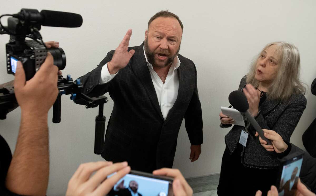 Conservative commentator Alex Jones speaks outside the hearing room prior to testimony by Google CEO Sundar Pichai during a House Judiciary Committee hearing on Capitol Hill in Washington, DC, December 11, 2018. -