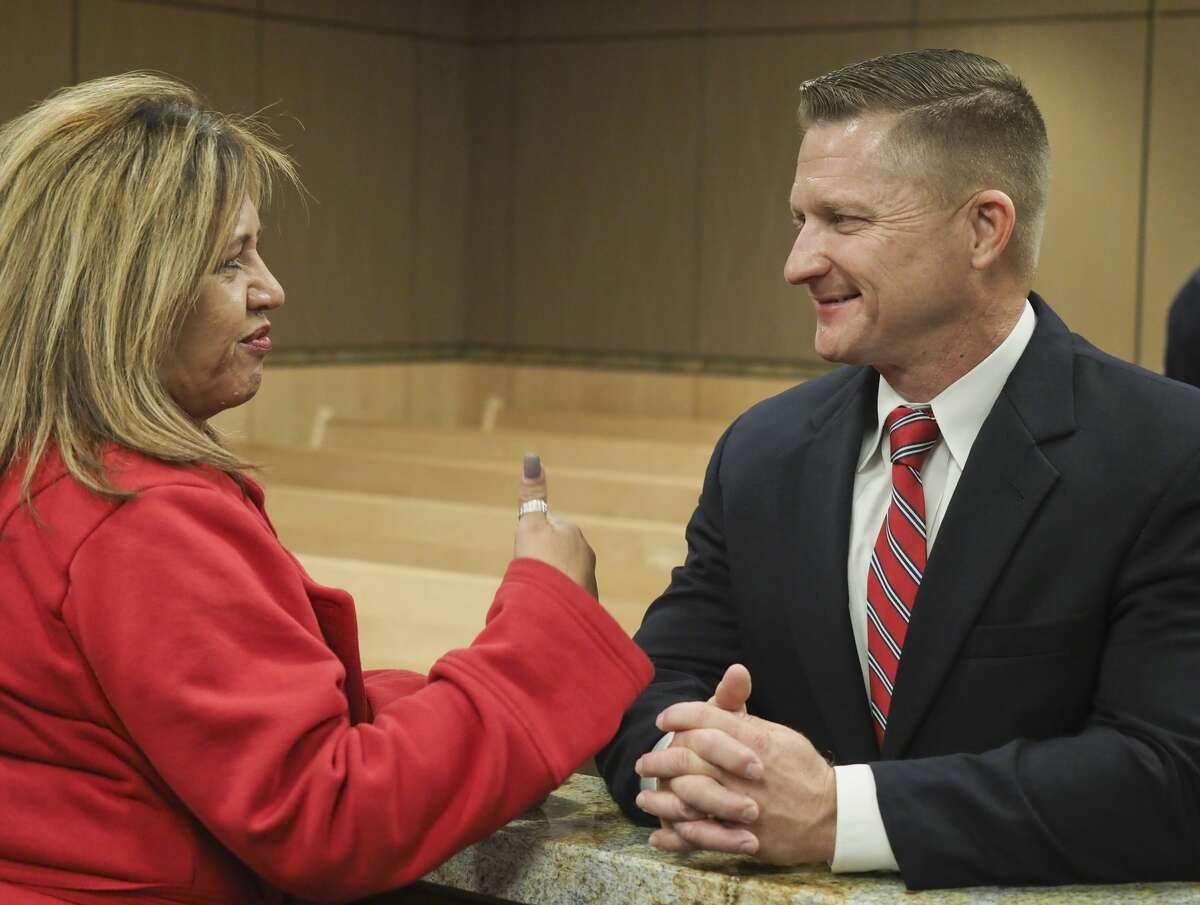 Rachel Stone talks with MPD Deputy Chief Seth Herman 12/11/18 evening at a community reception to talk with candidates for MPD chief at the Midland Municipal Courthouse. Tim Fischer/Reporter-Telegram