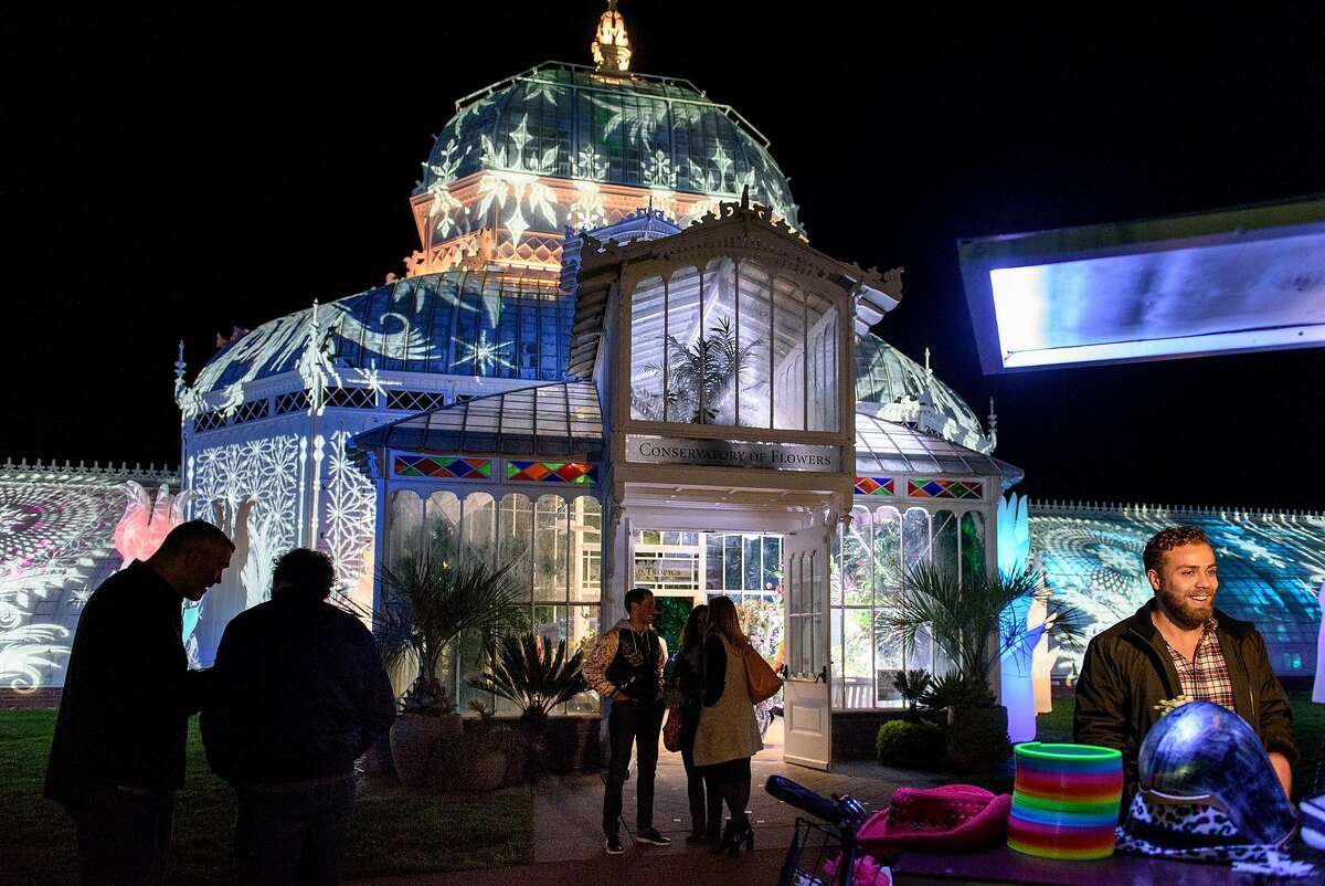 Guests mingle outside the new "Night Bloom" installation at the San Francisco Conservatory of Flowers in San Francisco, California, on Friday, November 30, 2018.