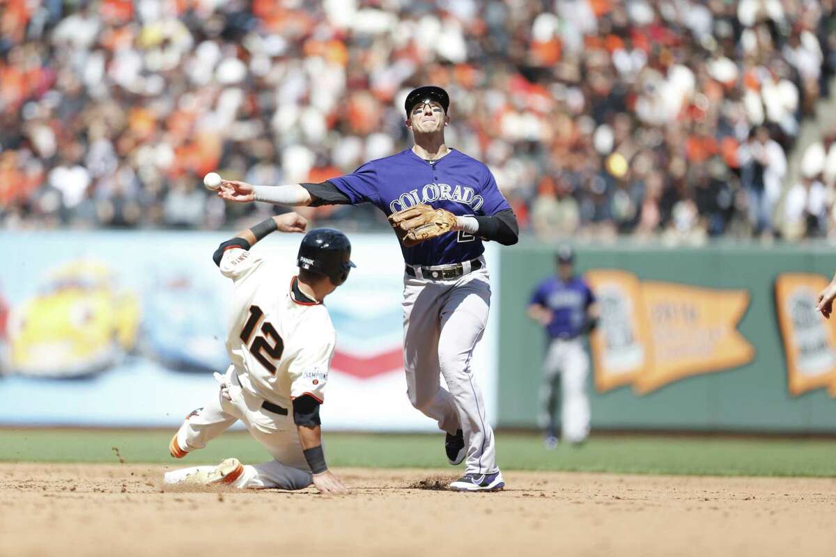 Troy Tulowitzki #2 of the Colorado Rockies gets the force out at second on Joe Panik #12 of the San Francisco Giants during the game at AT&T Park on April 13, 2015 in San Francisco, California. The Rockies defeated the Giants 2-0.