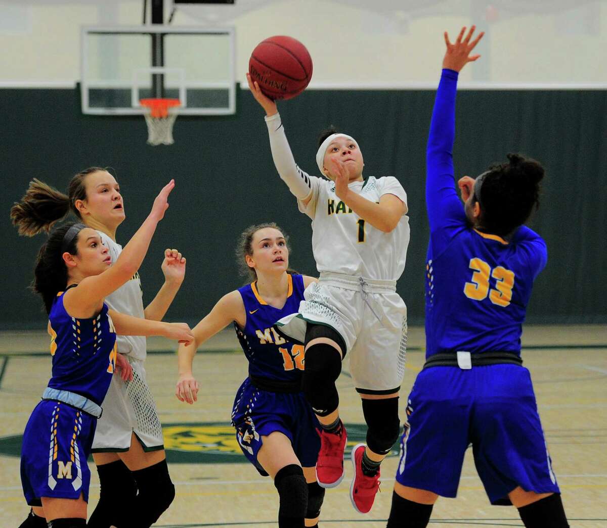 Hamden’s Asya Brandon goes up for a shot against Mercy on Tuesday at Hamden High. No. 5 Hamden defeated the No. 1 Tigers, 51-36, in the season opener for both teams.