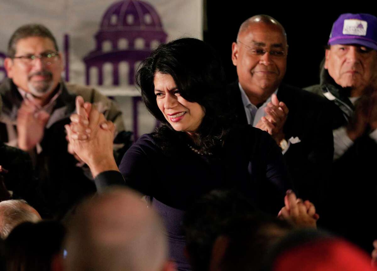 Carol Alvarado high fives attendants from the stage as she gives remarks at her watch party held at Raven Tower Tuesday, Dec. 11, 2018 in Houston, TX.